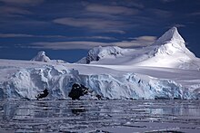 Glacier on Antarctic coast, mountain behind.jpg