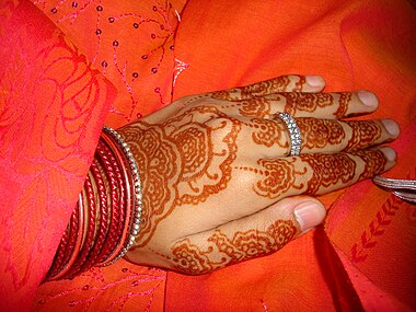 A bride's hand decorated with henna.