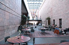 The museum's glass atrium (the west view) contains a cafe and gift shop. Dale Chihuly's Chihuly: Inside and Out is seen at the far end. Joslyn Atrium North.jpg