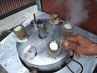 Kue putu being steamed