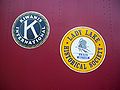 Train next to the old railroad depot. Closeup of decals on train. One is for Kiwanis International, the other for the Lady Lake Historical Society Train Museum.
