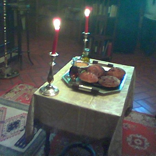 Table set with five loaves, wheat, wine and oil for artoklassia