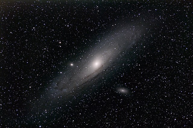 The Andromeda Galaxy and its satellite galaxy, Messier 110, to the bottom-right of the center