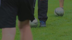 File:Men kicking footballs.webm