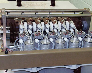 A bank of six 2000 A thyristors (white disks arranged in a row at top, and seen edge-on) Nelson Bipole Thyristors.jpg