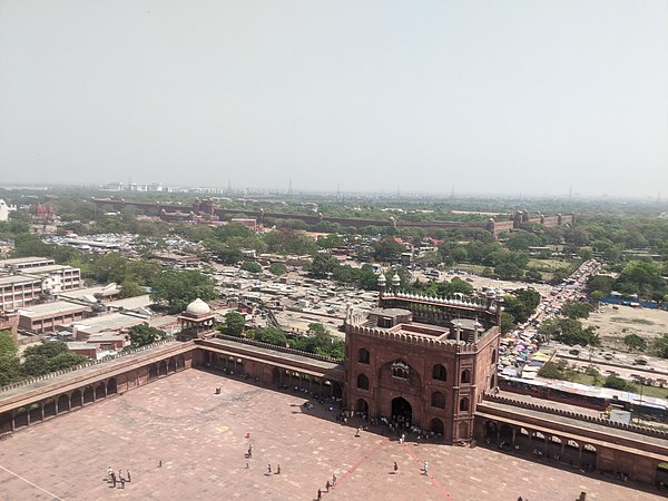 The walls of Red Fort (in the background) as seen from the top of Jama Masjid's tower