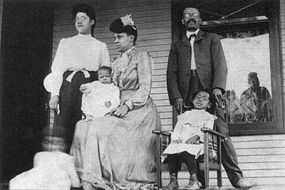 Family seated on the porch for a photo