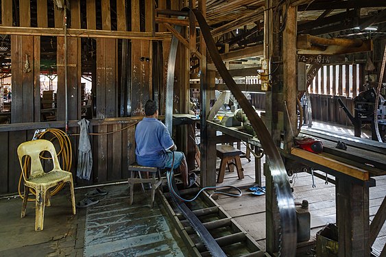 A Worker is welding steel teeth to a saw blade in a sawmill in Sandakan, Malaysia