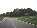 Signpost for Aigas golf course beside the A831 road, the main road running through the hamlet