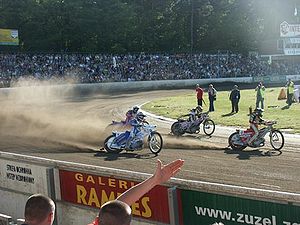 Speedway riders powersliding around a corner Speedway Zielona Gora.jpg