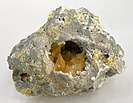 Nestled in its matrix vug are five golden-yellow crystals of sulfur