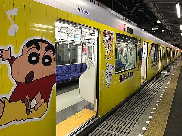 Train in special Crayon Shin-chan vinyl wrapping livery at Kurihashi Station, Japan