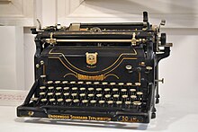 Photograph of a tall, black typewriter