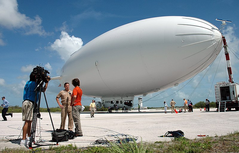 File:US Navy 080710-N-0311M-077 Fox News reporter Phil Keating interviews Persistent Maritime Unmanned Aircraft Systems Program Office 262 Program Manager Capt. Robert Dishman in front of the Skyship 600 blimp at Naval Air Station K.jpg