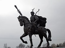 Modern statue of Jin emperor Taizong on horseback holding a weapon