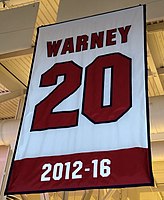 Warney's No. 20 was retired by Stony Brook in 2017. Warney Retired Number.jpg
