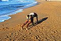 Couple doing yoga on the beach