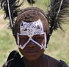 Young Maasai Warrior, with head-dress and face painting.