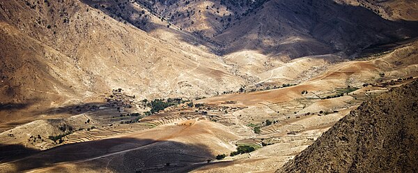 A village sits in a valley in the Hindu Kush Mountain Range in Laghman Province