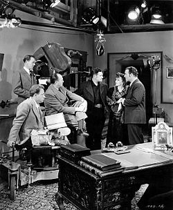L-R: Russell Harlan (cinematographer, standing), unknown, William C. McGann (director), Richard Dix, Frances Gifford & Preston Foster on the set of American Empire (1942) American Empire (1942) 1.jpg