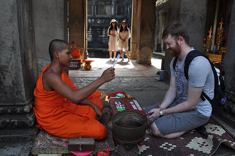 File:Buddhist monk and tourist at Angkor Wat.jpg