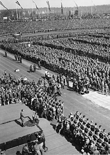 Hitler was the focal point at the 1934 Nuremberg Rally. Leni Riefenstahl and her crew are visible in front of the podium. Bundesarchiv Bild 183-2004-0312-504, Nurnberg, Reichsparteitag, Rede Adolf Hitler.jpg