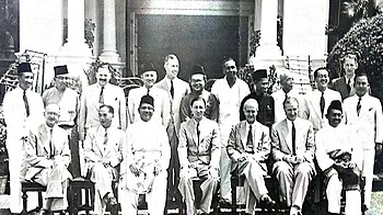 Members of the Cabinet of the Federation of Malaya, 1955: Sitting from the left: C.J. Thomas (Secretary of Finance), H. S. Lee (Minister of Transport), Tunku Abdul Rahman (Chief Minister and Minister of Home Affairs), Donald MacGillivray (High Commissioner), D.J. Watherson (Chief Secretary), J.P. Hogan (Attorney General), and Dr. Ismail Abdul Rahman (Minister of Natural Resources). Standing from the left: Bahaman Samsuddin (Deputy Minister of Home Affairs), Abdul Razak Hussein (Minister of Education), O.J. Spencer (Secretary of Economy), Abdul Aziz Ishak (Minister of Agriculture), A.H.P. Humphrey (Secretary of Defence), Suleiman Abdul Rahman (Minister of Local Government, Housing and Town Planning), V. T. Sambanthan (Minister of Labour), Sardon Jubir (Minister of Works), Leong Yew Koh (Minister of Health), Ong Yoke Lin (Minister of Communications, Telecommunications and Posts), A.S.H. Kemp (Secretary of State), and Too Joon Hing (Deputy Minister of Education). Cabinet of Malaya, 1955.jpg