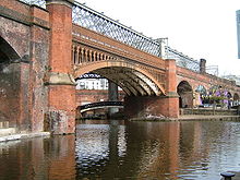 The cast iron arch of the 1849 viaduct with the Cornbrook viaduct over and behind Castlefield Viaducts 4689.JPG