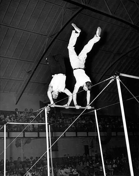 Cravat and Lancaster performing on the horizontal bars