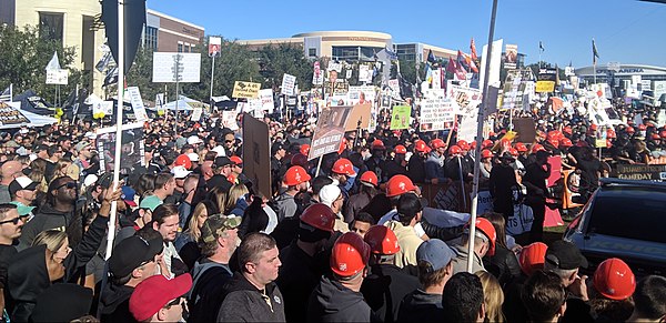 Fan-made signs and flags being held up behind the set help make up the atmosphere of GameDay, as seen here at UCF in November 2018.