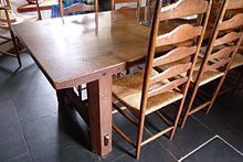 Sidney Barnsley's oak dining table, with Ernest Gimson's ladder-back chairs Dining table by Sidney Barnsley, Stoneywell, Leicestershire.jpg