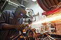 Flickr - Official U.S. Navy Imagery - A Sailor grinds a metal fitting in the general workshop..jpg Item:Q6462