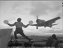A Grumman Hellcat landing on HMS Ravager as the batsman makes the all-clear signal Grumman Hellcat landing on HMS Ravager A21287.jpg