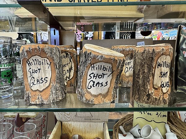 "Hillbilly shot glass" inscribed on a wooden shot glass at a gift shop in Nashville, Indiana.