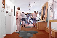 Visitors exploring an art exhibition in the VanGo Inside the VanGo! Museum on Wheels.jpg