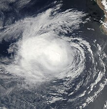 A satellite image of a tropical storm over the Eastern Pacific Ocean, off the coast of the southern Baja California peninsula