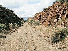 Rail cut on the Yakima Training Center in the eastern end of the Iron Horse State Park portion of the John Wayne Pioneer Trail as it nears the Columbia River south of Vantage John Wayne Pioneer Trail - east end of Iron Horse park.jpg