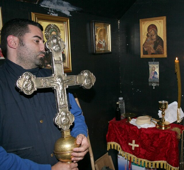 The Cross of Vladimir, held by Milan Andrović during the Pentecost liturgy at the summit of Mount Rumija (2001)