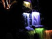 Lit waterfall and lit tree trunks in Pukekura Park (Festival of Lights).jpg