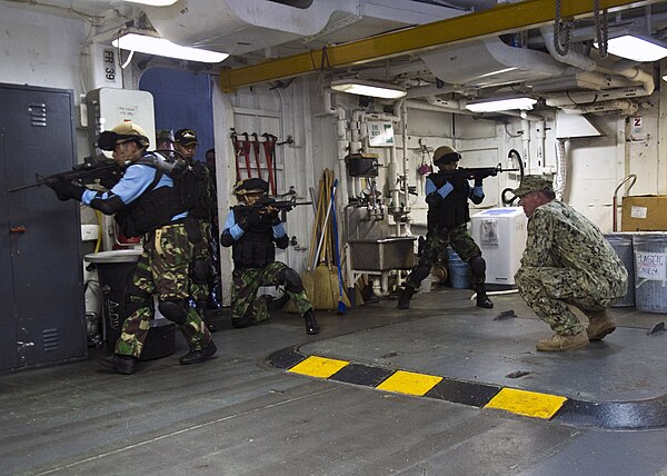 Kopaska frogmen simulate seizing a room in a Naval warship during training with the US Navy