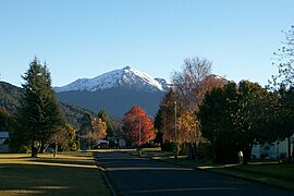 Autumn view along Mararoa Drive with snow-dusted Mount Moturau in the distance