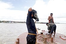 Coal divers prepare to dive in the Yangon River