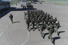 Russian troops marching at the airport.