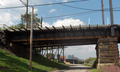 Schuylkill Arsenal Railroad Bridge, built about 1905 by the Pennsylvania Railroad as a formerly electrified, two track, deck truss, (fixed shut) swing bridge across the Schuylkill River in the University City neighborhood in Philadelphia, Pennsylvania. Now owned by CSX Transportation. Looking north at the western girder approach to the bridge.