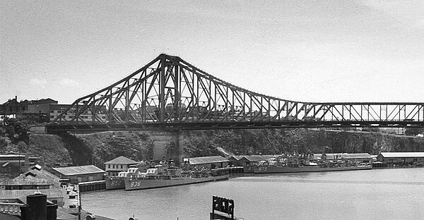 George K. MacKenzie, Leonard F. Mason, Henry W. Tucker, and Rupertus under the Story Bridge, Brisbane, Australia in January 1958.