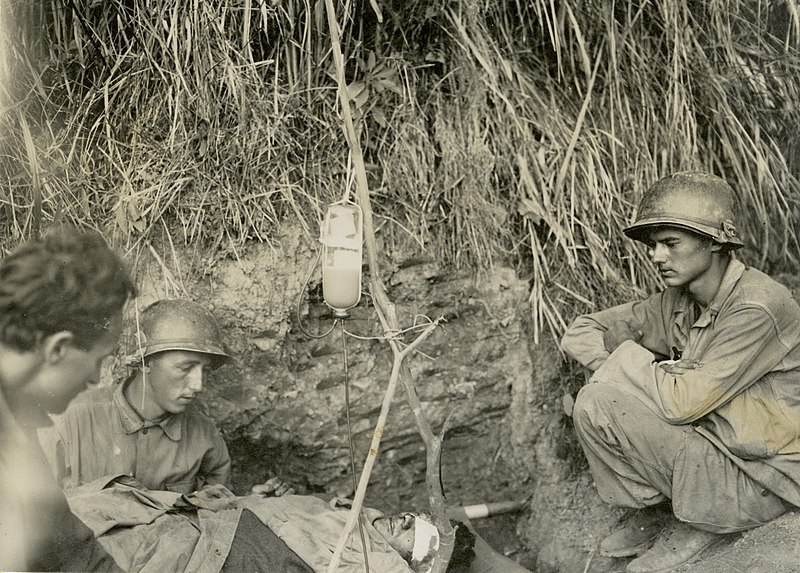 File:SC 265138 - A wounded soldier is given blood plasma by medics directly behind the front lines near San Nicholas, Luzon. 7 March, 1945. (49798100096).jpg