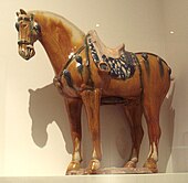 A sancai-glazed horse statue from the Tang Dynasty (618-907) showing a rider's stirrup connected to the saddle SancaiHorseTang7-8thCentury.JPG