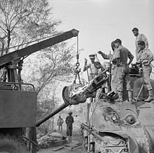 An M3 is lifted out of a Sherman tank at 5th Indian Division's tank workshop near Taungtha, Burma, 29 March 1945