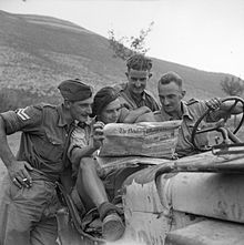 The British Army in Italy 1943: Men of the 2/6th Queen's Regiment read the Newbury Weekly News in their jeep, 29 September 1943. The British Army in Italy 1943 NA7447.jpg