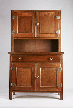 wooden furniture piece with shallower shelves on top of a table with storage underneath